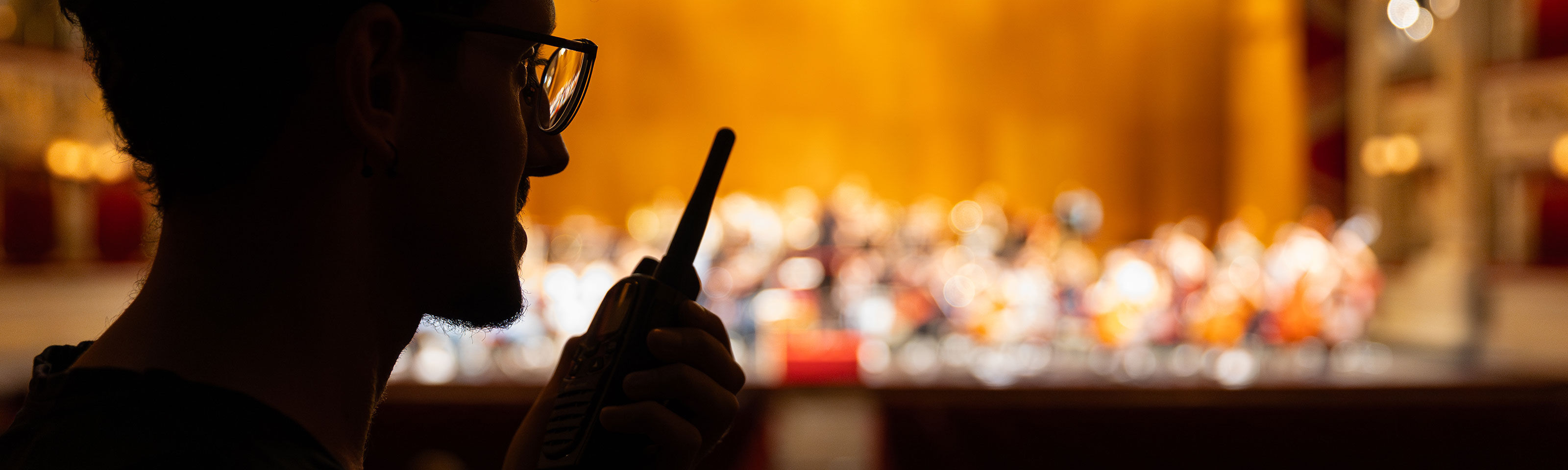 sound technician sets up a microphone system in the theater