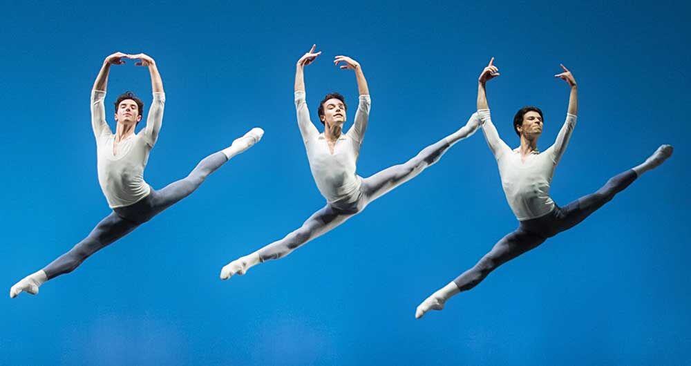 three dancers engaged in a grand jete jump